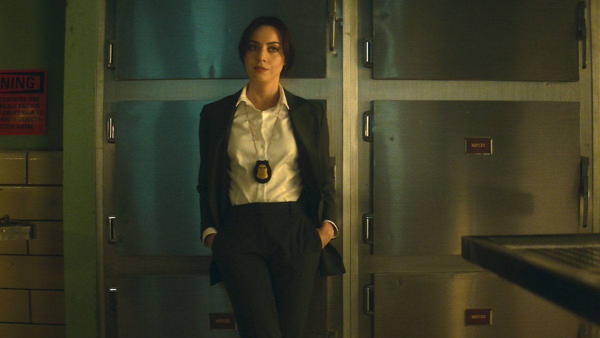 Aubrey Plaza dressed as a cop in a morgue on Agatha All Along