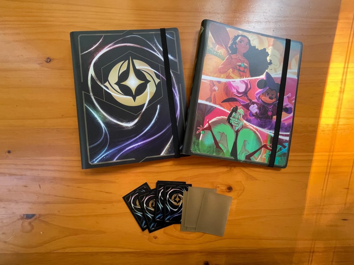 Disney Lorcana Shimmering Skies portfolios and card sleeves on a wood table