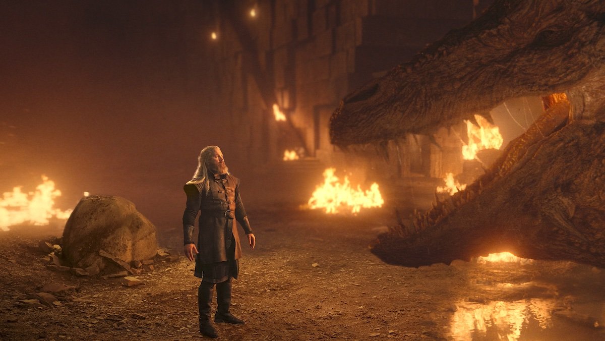 Hugh stands before Vermithor as fires rage around him on House of the Dragon
