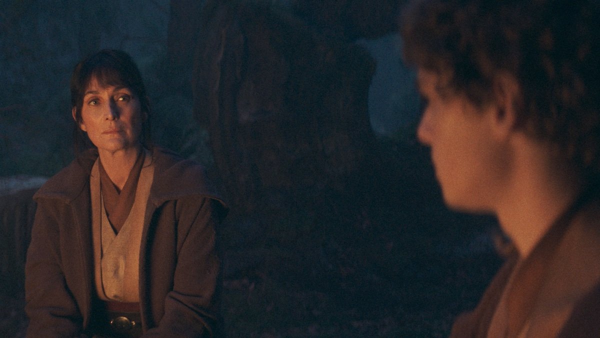 Indara and Torbin sit by a fire on The Acolyte