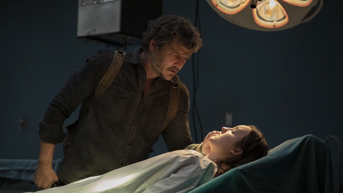 Joel looks at Ellie, sedated on a surgical table, in The Last of Us finale.